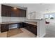 Bonus room features a built-in desk with granite countertops, dark wood cabinets and a view of the lounging area at 14823 Borromini St, Montverde, FL 34756