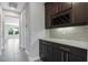 Elegant butler pantry with wine rack, granite countertop and mosaic backsplash at 14823 Borromini St, Montverde, FL 34756