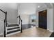 Welcoming entryway with staircase, dark wood floors, chandelier, and access to the dining room at 14823 Borromini St, Montverde, FL 34756