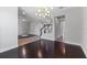 Inviting foyer with a view into the living room and dining room, showcasing hardwood and tile floors at 14823 Borromini St, Montverde, FL 34756