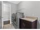 Well-equipped laundry room with stainless steel appliances and ample storage at 14823 Borromini St, Montverde, FL 34756