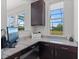 Bright home office features granite countertops, dark wood cabinets and large windows at 14823 Borromini St, Montverde, FL 34756