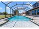 A screened-in pool and spa offer a beautiful view of the home and green backyard at 14823 Borromini St, Montverde, FL 34756