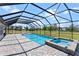 A screened-in pool and spa offer a beautiful view of the green backyard at 14823 Borromini St, Montverde, FL 34756