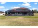 Back exterior aerial view of a screened-in pool and spa with a spacious yard, great for entertaining at 14823 Borromini St, Montverde, FL 34756