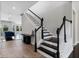 Elegant staircase with dark wood treads and white risers, leading to the upper level of the home at 14823 Borromini St, Montverde, FL 34756