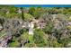 Aerial view of the wooded backyard and single-story home with a peak of the lake in the distance at 1503 Holly Rd, Lakeland, FL 33801