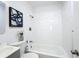 Clean white tiled bathroom with modern fixtures and decor at 1503 Holly Rd, Lakeland, FL 33801