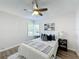 Cozy bedroom featuring a ceiling fan, stylish decor, and a bright bay window at 1503 Holly Rd, Lakeland, FL 33801