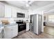 Modern kitchen featuring stainless steel appliances, granite countertops, and bright white cabinets at 1503 Holly Rd, Lakeland, FL 33801