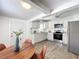 Bright kitchen flows into the dining area, featuring stainless appliances, and stone countertops at 1503 Holly Rd, Lakeland, FL 33801