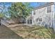 Home's backyard features mature shade trees and a storage shed; sliding glass doors open to the back of the house at 155 Aunt Polly Ct, Orlando, FL 32828