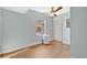 Cozy spare bedroom with wood-look floors, fan, and natural light from one window at 155 Aunt Polly Ct, Orlando, FL 32828