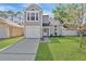 Charming two-story home with light grey siding, well-manicured lawn, and attached garage at 155 Aunt Polly Ct, Orlando, FL 32828