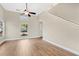 Bright living room with high ceilings, light-toned walls, wood-look floors, and modern ceiling fan at 155 Aunt Polly Ct, Orlando, FL 32828