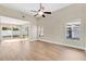 Spacious living room featuring wood-look flooring, ample natural light, and modern ceiling fan at 155 Aunt Polly Ct, Orlando, FL 32828