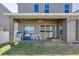 View of covered back patio with ceiling fan, sliding glass door, and backyard, enhancing outdoor living at 15837 Sweet Lemon Way, Winter Garden, FL 34787