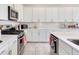 A modern kitchen with stainless appliances, subway tile backsplash, and white cabinetry at 15837 Sweet Lemon Way, Winter Garden, FL 34787