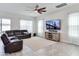 Cozy living area with neutral color, large television and lots of natural light at 15837 Sweet Lemon Way, Winter Garden, FL 34787