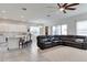 Bright, open-concept living room with tile floors and large sectional sofa at 15837 Sweet Lemon Way, Winter Garden, FL 34787