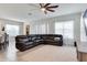 Bright living room with ceiling fan, with a large sectional couch and neutral carpet at 15837 Sweet Lemon Way, Winter Garden, FL 34787