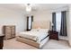 Well-lit main bedroom with neutral decor, comfortable bed, and matching nightstands at 15837 Sweet Lemon Way, Winter Garden, FL 34787