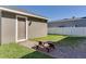 An outbuilding with a picnic table provides a space to relax in the backyard at 15837 Sweet Lemon Way, Winter Garden, FL 34787