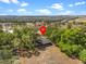 Expansive aerial view showcases property's surrounding greenery and neighborhood landscape under a sunny sky at 16510 Quarter Horse Ct, Montverde, FL 34756