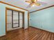 Bedroom with a ceiling fan, closet, and wood-look laminate flooring at 16510 Quarter Horse Ct, Montverde, FL 34756