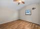 Bedroom with hardwood floors, ceiling fan, and bright window at 16510 Quarter Horse Ct, Montverde, FL 34756