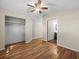 Bedroom featuring wood floors, a ceiling fan, and closet at 16510 Quarter Horse Ct, Montverde, FL 34756