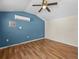 Bedroom featuring wood floors, a ceiling fan, and an air conditioning unit at 16510 Quarter Horse Ct, Montverde, FL 34756