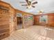 Living room featuring wood paneling, ceiling fans, and tile flooring at 16510 Quarter Horse Ct, Montverde, FL 34756