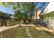 Landscaped backyard featuring a fire pit with chairs on a wooden deck and stone walkways through the garden at 1756 Waterbeach Ct, Apopka, FL 32703