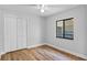 Clean bedroom features wood floors, a ceiling fan, and a window that offers natural light at 1756 Waterbeach Ct, Apopka, FL 32703