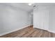 Light-filled bedroom features wood floors, double closet, and a ceiling fan at 1756 Waterbeach Ct, Apopka, FL 32703