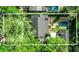 Aerial view of a home with mature tree coverage showing pool, outdoor fireplace, and patio at 1911 Stonehurst Rd, Winter Park, FL 32789