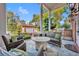 Relaxing covered porch with ample seating, outdoor grill, and scenic views of the lush backyard and detached garage at 1911 Stonehurst Rd, Winter Park, FL 32789