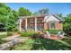 Charming backyard featuring a brick patio, fire pit, lush landscaping, and a grand colonial-style home at 1911 Stonehurst Rd, Winter Park, FL 32789