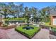 Picturesque backyard featuring a fountain, pool, manicured hedges, and serene landscaping offering a private retreat at 1911 Stonehurst Rd, Winter Park, FL 32789