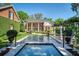 Expansive backyard showcasing the pool, patio, and meticulously maintained landscaping of the estate at 1911 Stonehurst Rd, Winter Park, FL 32789