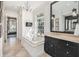 Bright bathroom with a soaking tub, black vanity, and luxurious finishes at 1911 Stonehurst Rd, Winter Park, FL 32789