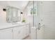 Updated bathroom showcasing subway tile in the shower, a white vanity with granite counters, and a window at 1911 Stonehurst Rd, Winter Park, FL 32789