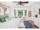 Serene bedroom features a sitting area with bay windows and natural light at 1911 Stonehurst Rd, Winter Park, FL 32789