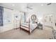 Charming bedroom with a four-poster bed, dresser, and neutral color scheme at 1911 Stonehurst Rd, Winter Park, FL 32789