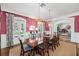 Formal dining room boasts bold wallpaper and an elegant chandelier at 1911 Stonehurst Rd, Winter Park, FL 32789