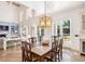 Elegant dining room with a large chandelier, high ceilings, and access to the backyard at 1911 Stonehurst Rd, Winter Park, FL 32789