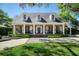 Beautiful home with classic architecture, including dormer windows, columns and a manicured lawn at 1911 Stonehurst Rd, Winter Park, FL 32789