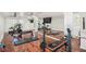 Spacious home gym with mirrored wall, mounted TVs, and varied equipment on hardwood floors at 1911 Stonehurst Rd, Winter Park, FL 32789