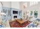 Cozy living room featuring a fireplace, custom built-ins, and ample natural light at 1911 Stonehurst Rd, Winter Park, FL 32789